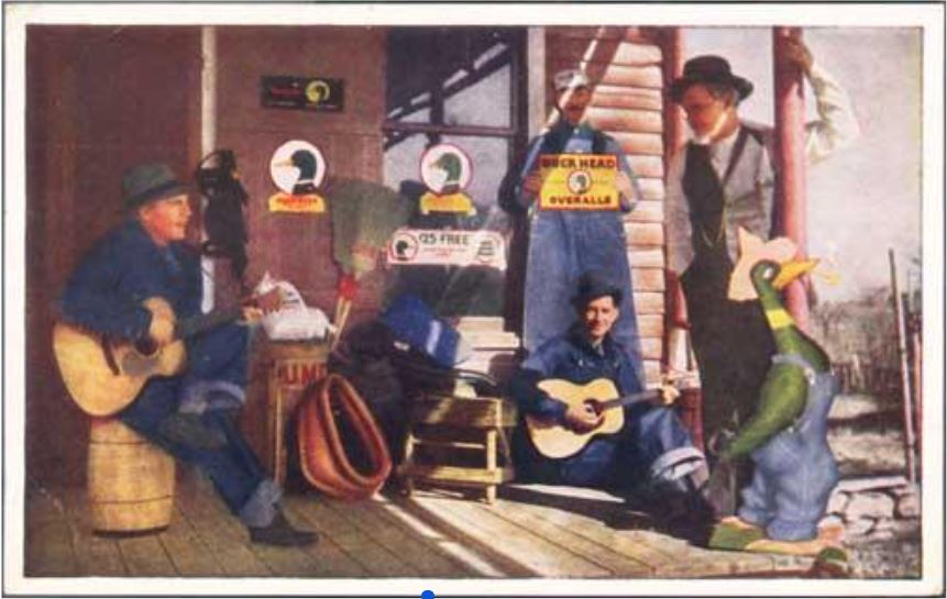 A lively group of people in overalls, with two men playing guitars, a woman holding a sign for "Duck Head Overalls," and a whimsical duck statue, suggest a playful vibe of rural Americana.